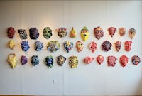 a group of colorful masks on a wall