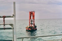 a red buoy in the middle of the ocean