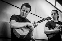 two people playing ukulele in a black and white photo