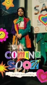 a woman in a colorful outfit standing in front of a store